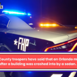 Orange County troopers have said that an Orlando man died after a building was crashed into by a sedan.